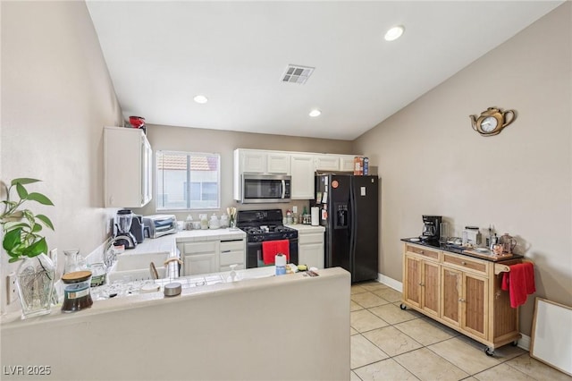 628 Bay Bridge Dr, North Las Vegas, NV 89032 - kitchen featuring black appliances, white cabinetry, tile countertops, a sink, and light tile patterned floors