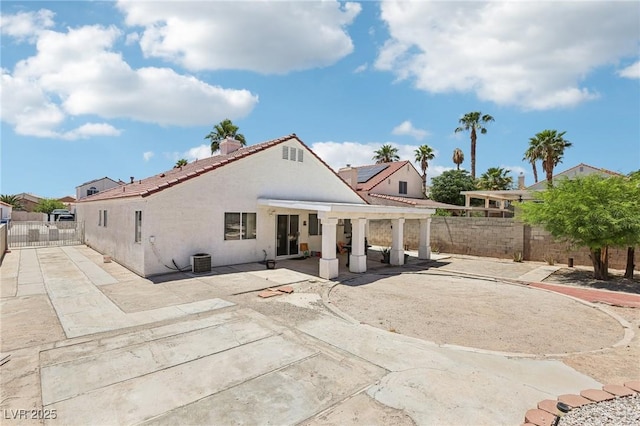 628 Bay Bridge Dr, North Las Vegas, NV 89032 - back of property with a patio area, a pergola, a fenced backyard, a tiled roof, and stucco siding