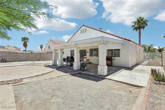 628 Bay Bridge Dr, North Las Vegas, NV 89032 - rear view of property featuring a patio area, stucco siding, a fenced backyard, and a tiled roof