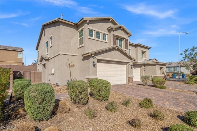 7051 Denio Island St, North Las Vegas, NV 89084 - traditional home featuring stucco siding, an attached garage, and decorative driveway