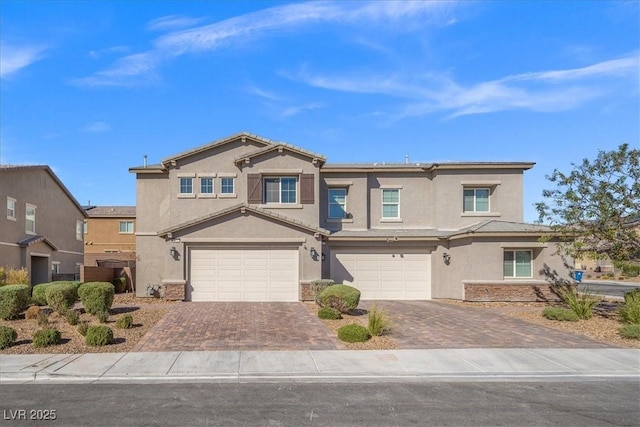7051 Denio Island St, North Las Vegas, NV 89084 - view of front of home with stucco siding, decorative driveway, and a garage