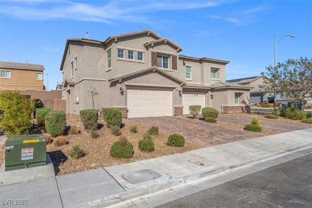 7051 Denio Island St, North Las Vegas, NV 89084 - traditional-style house featuring stucco siding, an attached garage, driveway, and stone siding