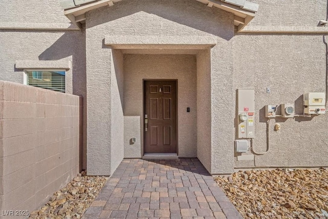 7051 Denio Island St, North Las Vegas, NV 89084 - doorway to property with stucco siding