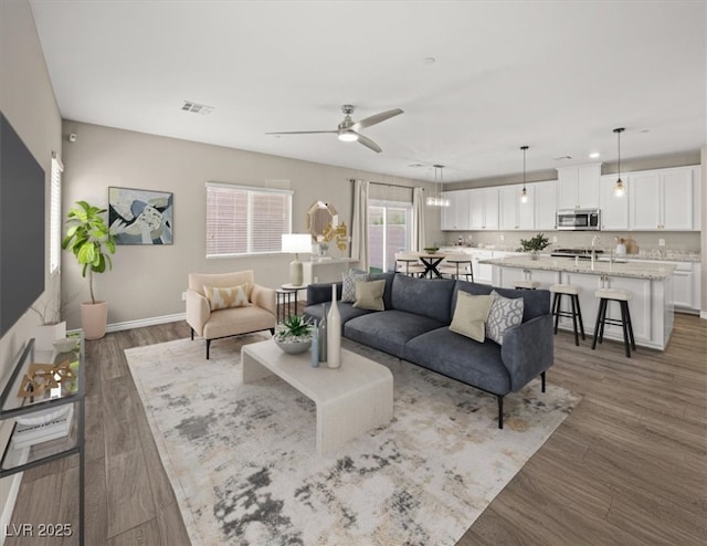 7051 Denio Island St, North Las Vegas, NV 89084 - living area featuring ceiling fan, wood finished floors, and baseboards