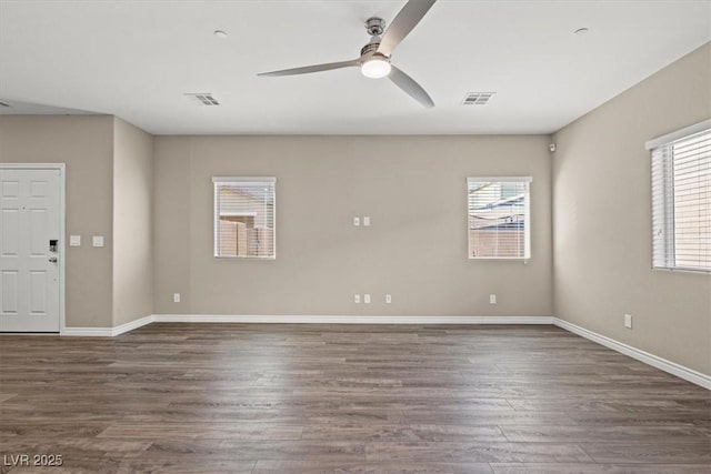 7051 Denio Island St, North Las Vegas, NV 89084 - unfurnished room with plenty of natural light, ceiling fan, wood finished floors, and baseboards