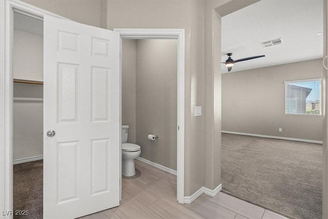 7051 Denio Island St, North Las Vegas, NV 89084 - bathroom with toilet, baseboards, and ceiling fan