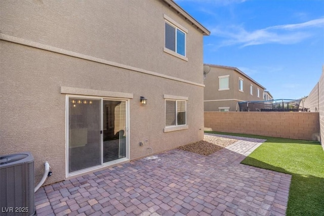 7051 Denio Island St, North Las Vegas, NV 89084 - rear view of property featuring cooling unit, a fenced backyard, a patio area, and stucco siding