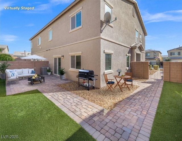 7051 Denio Island St, North Las Vegas, NV 89084 - back of house featuring outdoor lounge area, a patio area, stucco siding, and a gate