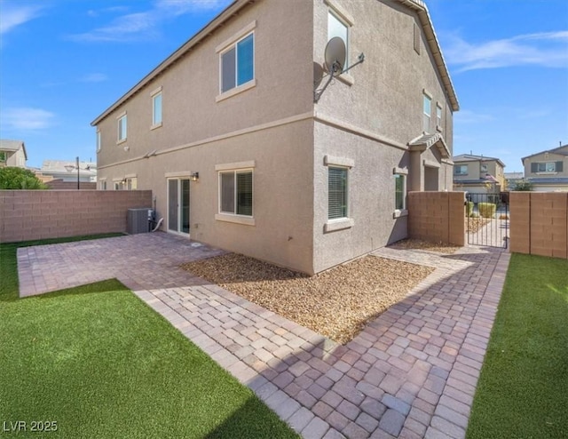 7051 Denio Island St, North Las Vegas, NV 89084 - back of house featuring cooling unit, a patio, a gate, and stucco siding