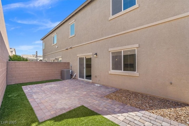 7051 Denio Island St, North Las Vegas, NV 89084 - rear view of property with stucco siding, a patio, and central air condition unit