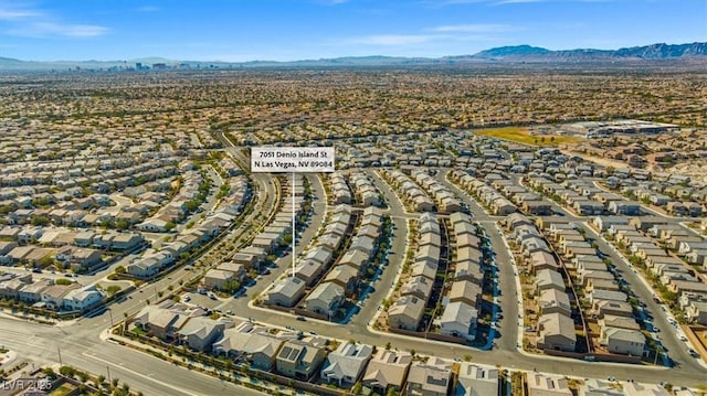 7051 Denio Island St, North Las Vegas, NV 89084 - aerial view of property and surrounding area with nearby suburban area and a mountainous background