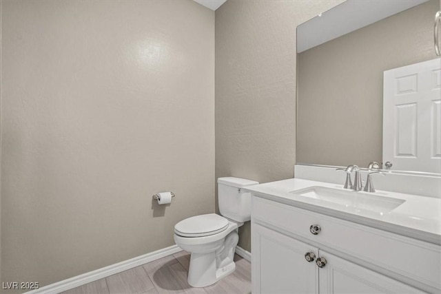 7051 Denio Island St, North Las Vegas, NV 89084 - bathroom featuring toilet, vanity, and baseboards