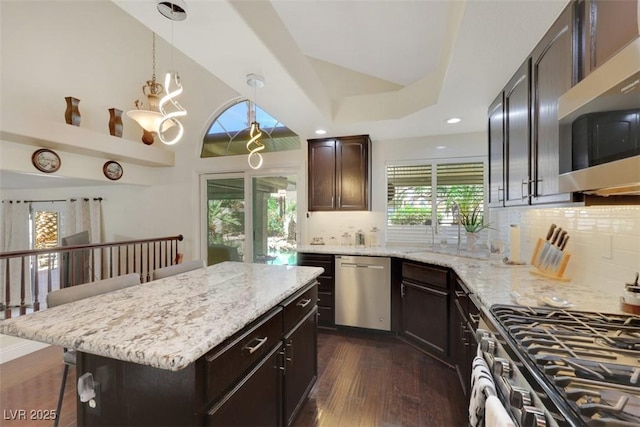 8224 Fawn Meadow Ave, Las Vegas, NV 89149 - kitchen with stainless steel appliances, dark wood-style flooring, dark brown cabinetry, light stone countertops, and recessed lighting