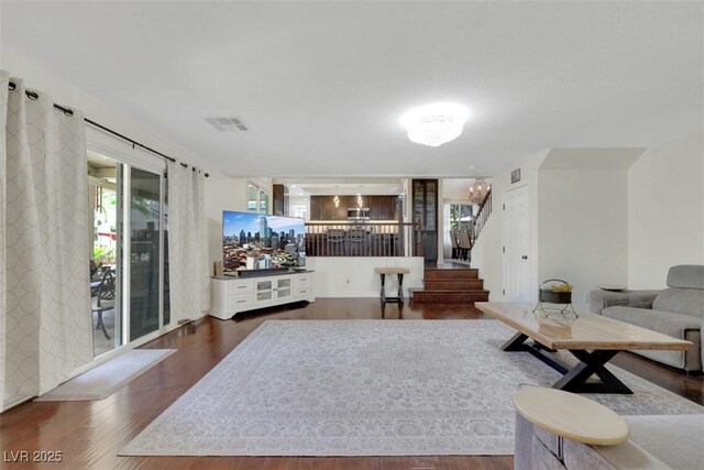8224 Fawn Meadow Ave, Las Vegas, NV 89149 - living room featuring a chandelier, wood finished floors, and stairs
