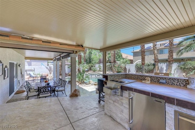 8224 Fawn Meadow Ave, Las Vegas, NV 89149 - fenced backyard with a patio, outdoor dining area, and exterior kitchen