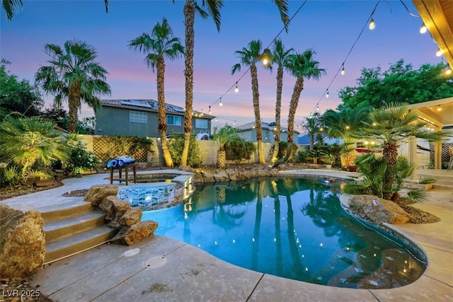 8224 Fawn Meadow Ave, Las Vegas, NV 89149 - pool at dusk with a fenced backyard and a pool with connected hot tub