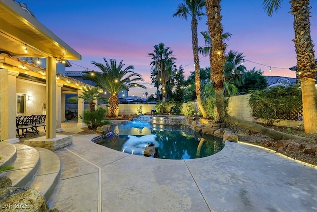 8224 Fawn Meadow Ave, Las Vegas, NV 89149 - pool at dusk with a patio, a fenced backyard, and a pool with connected hot tub