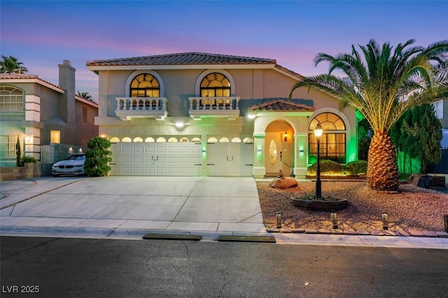 8224 Fawn Meadow Ave, Las Vegas, NV 89149 - mediterranean / spanish home with a garage, concrete driveway, stucco siding, and a tile roof