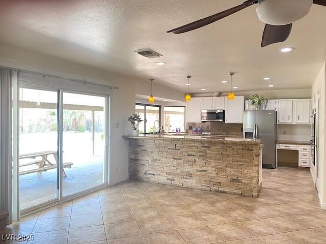 6315 Eldora Ave, Las Vegas, NV 89146 - kitchen with appliances with stainless steel finishes, a peninsula, white cabinets, ceiling fan, and light tile patterned flooring