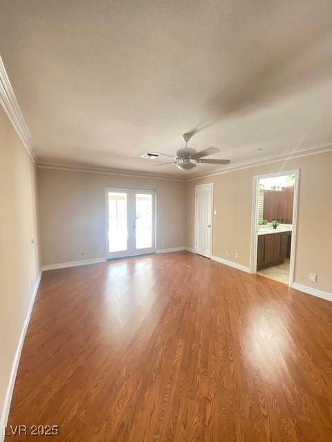 6315 Eldora Ave, Las Vegas, NV 89146 - empty room featuring crown molding, wood finished floors, ceiling fan, and baseboards