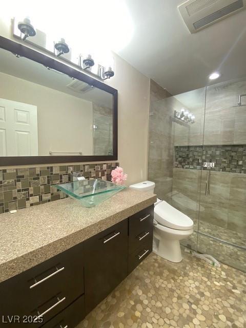 6315 Eldora Ave, Las Vegas, NV 89146 - full bathroom with vanity, a stall shower, toilet, and tasteful backsplash