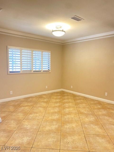 6315 Eldora Ave, Las Vegas, NV 89146 - unfurnished room featuring crown molding, light tile patterned floors, and baseboards
