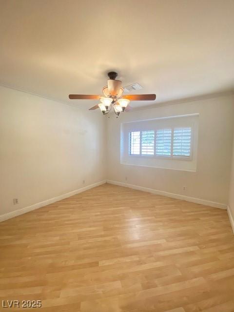 6315 Eldora Ave, Las Vegas, NV 89146 - unfurnished room featuring light wood-style floors, baseboards, a ceiling fan, and ornamental molding
