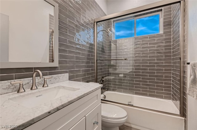 4740 W Agate Ave, Las Vegas, NV 89139 - bathroom with toilet, vanity, combined bath / shower with glass door, and tile walls