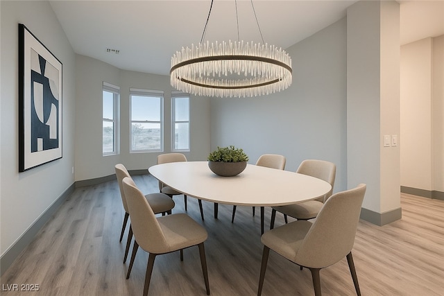 4740 W Agate Ave, Las Vegas, NV 89139 - dining area with light wood-style flooring, baseboards, and a chandelier