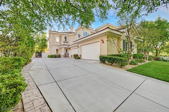 1809 White Hawk Ct, Las Vegas, NV 89134 - view of front facade featuring stucco siding, driveway, an attached garage, and a chimney