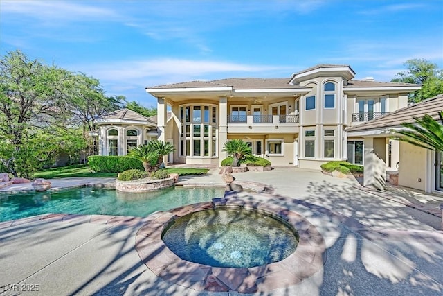 1809 White Hawk Ct, Las Vegas, NV 89134 - rear view of house featuring a balcony, a patio, stucco siding, and a pool with connected hot tub