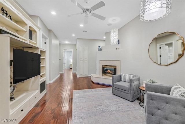 1809 White Hawk Ct, Las Vegas, NV 89134 - living room with dark wood-style flooring, a glass covered fireplace, ceiling fan, recessed lighting, and baseboards