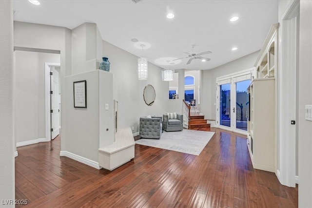 1809 White Hawk Ct, Las Vegas, NV 89134 - living area with dark wood-type flooring, baseboards, stairs, a ceiling fan, and arched walkways