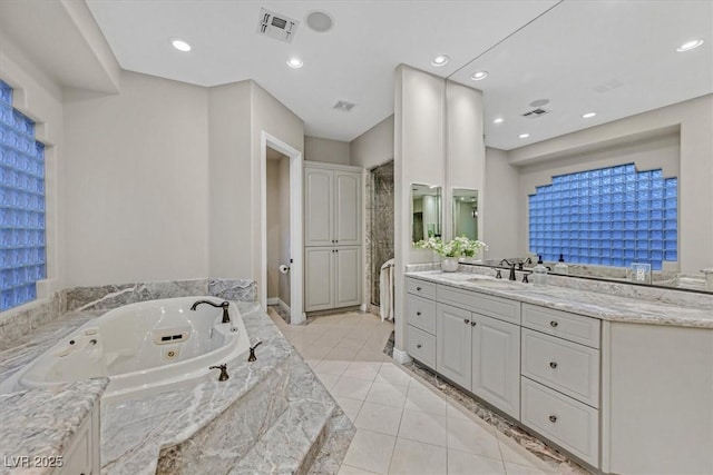 1809 White Hawk Ct, Las Vegas, NV 89134 - bathroom with vanity, a stall shower, tile patterned flooring, a jetted tub, and recessed lighting