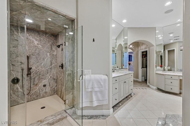 1809 White Hawk Ct, Las Vegas, NV 89134 - bathroom with a marble finish shower, baseboards, two vanities, recessed lighting, and tile patterned floors