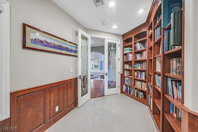 1809 White Hawk Ct, Las Vegas, NV 89134 - sitting room with french doors, recessed lighting, arched walkways, light carpet, and built in shelves