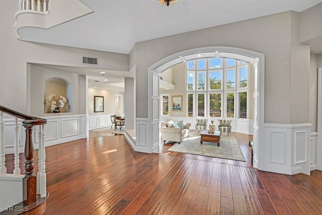 1809 White Hawk Ct, Las Vegas, NV 89134 - entryway featuring a decorative wall, hardwood / wood-style flooring, arched walkways, wainscoting, and stairs