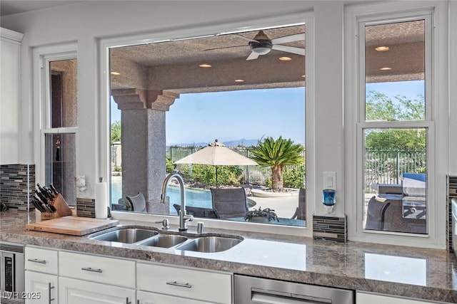 9301 Queen Charlotte Dr, Las Vegas, NV 89145 - kitchen with a sink, healthy amount of natural light, stainless steel microwave, dishwashing machine, and recessed lighting