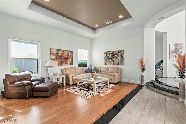 9301 Queen Charlotte Dr, Las Vegas, NV 89145 - living area with a tray ceiling, arched walkways, wood finished floors, baseboards, and recessed lighting