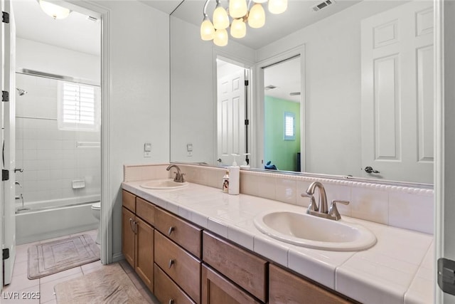 9301 Queen Charlotte Dr, Las Vegas, NV 89145 - bathroom featuring double vanity, toilet, shower / bath combination, and a chandelier