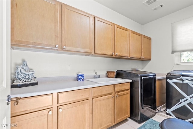 9301 Queen Charlotte Dr, Las Vegas, NV 89145 - laundry area featuring cabinet space, washer and dryer, and light tile patterned floors