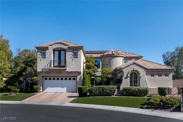 9301 Queen Charlotte Dr, Las Vegas, NV 89145 - mediterranean / spanish-style home with french doors, stucco siding, a garage, a balcony, and decorative driveway