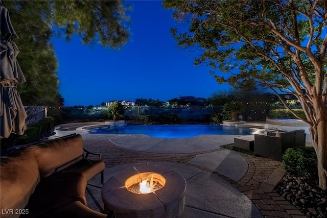 9301 Queen Charlotte Dr, Las Vegas, NV 89145 - pool at twilight featuring an in-ground hot tub, a fire pit, a patio area, and an outdoor pool