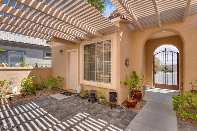 10361 Profeta Ct, Las Vegas, NV 89135 - doorway to property featuring stucco siding, a pergola, and a patio
