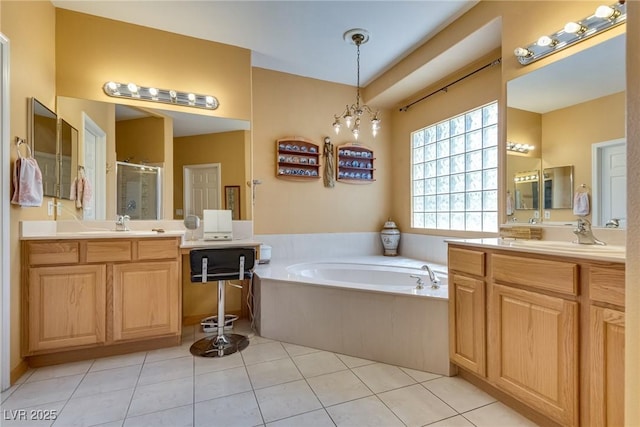 10361 Profeta Ct, Las Vegas, NV 89135 - full bath with a stall shower, a bath, two vanities, and tile patterned floors