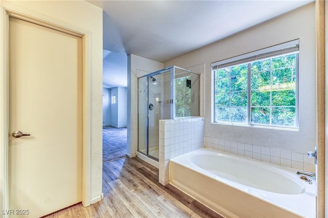 7900 Dutch Canyon Ct, Las Vegas, NV 89131 - bathroom with a bath, a stall shower, and wood finished floors