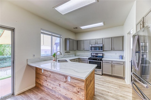 7900 Dutch Canyon Ct, Las Vegas, NV 89131 - kitchen with stainless steel appliances, gray cabinets, and light stone counters