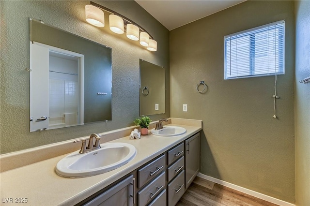 7900 Dutch Canyon Ct, Las Vegas, NV 89131 - full bath with double vanity, wood finished floors, and a textured wall
