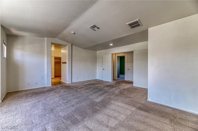 7900 Dutch Canyon Ct, Las Vegas, NV 89131 - unfurnished room featuring carpet floors, vaulted ceiling, and a textured ceiling
