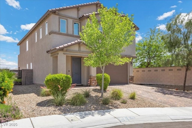 4030 Midnight Crest Ave, North Las Vegas, NV 89031 - view of front of house with a garage, stucco siding, decorative driveway, and a tile roof